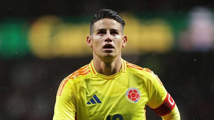 James Rodríguez con la camiseta de la Selección Colombia levantando el balón en un partido oficial